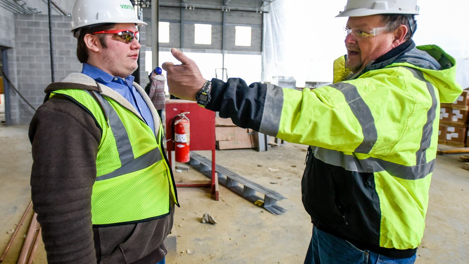 Middletown High School student Brandon Myszka, left, with jobsite superintendent Bill Varney at the construction site of the new Middletown Middle School. NICK GRAHAM/STAFF