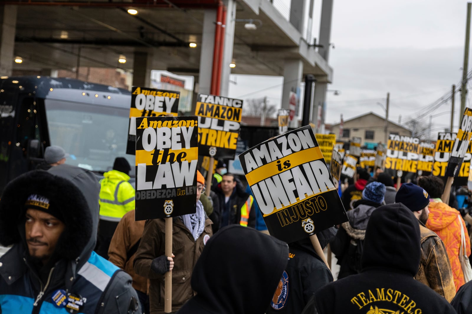 Amazon workers and members of the International Brotherhood of Teamsters picket in front of the Amazon fulfillment center in the Queens borough of New York, Friday, Dec. 20, 2024. (AP Photo/Stefan Jeremiah)