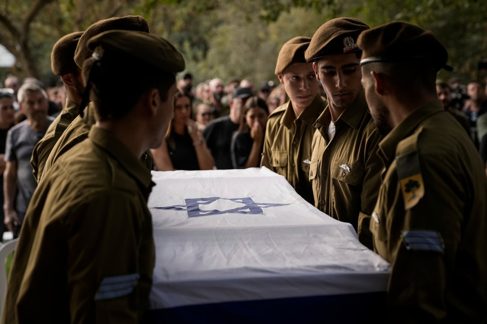 Israeli soldiers carry the flagged-covered coffin of Sgt. Amitai Alon, killed by a Hezbollah drone attack, during his funeral near Ramot Naftali, Israel, Monday, Oct. 14, 2024. (AP Photo/Leo Correa)