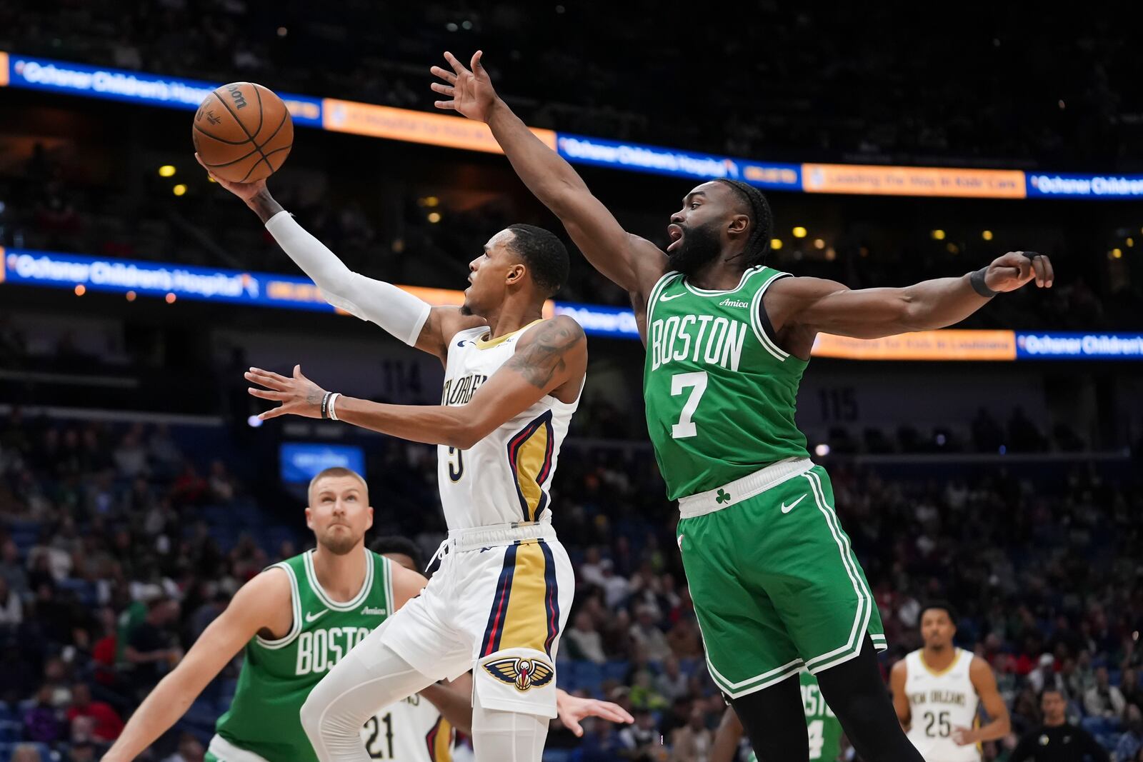 New Orleans Pelicans guard Dejounte Murray (5) goes to the basket against Boston Celtics guard Jaylen Brown (7) in the first half of an NBA basketball game in New Orleans, Friday, Jan. 31, 2025. (AP Photo/Gerald Herbert)