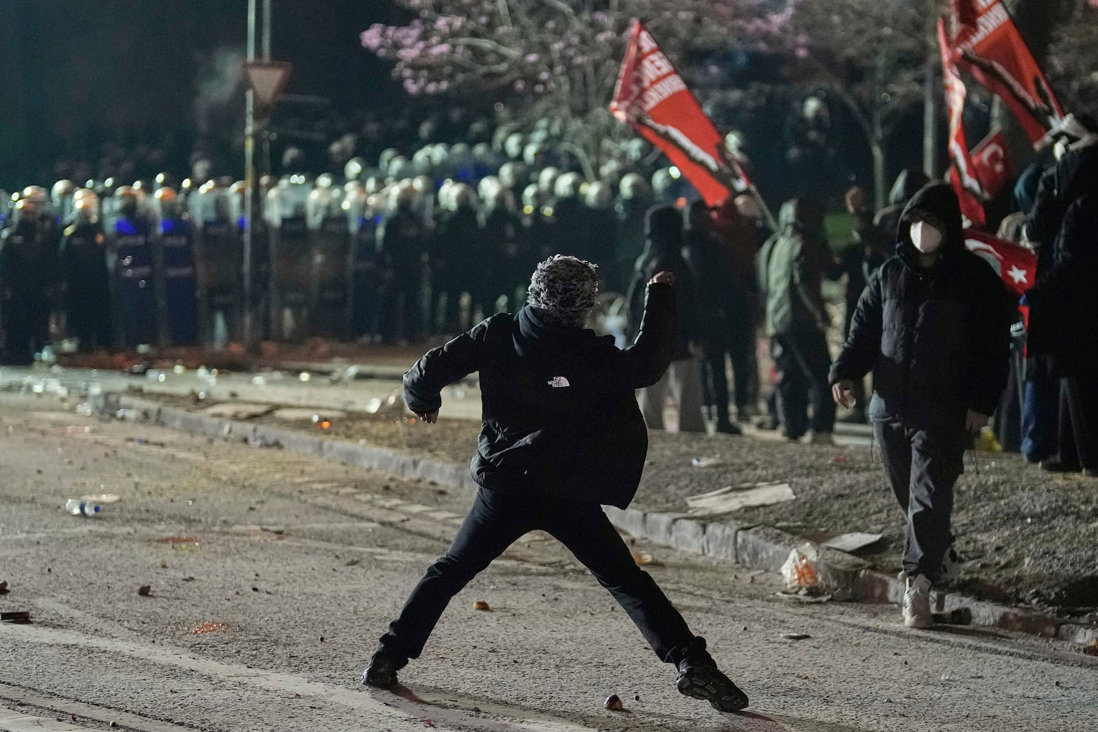 Protesters clash with riot police during a protest against the arrest of Istanbul's Mayor Ekrem Imamoglu, in Istanbul, Turkey, Saturday, March 22, 2025. (AP Photo/Khalil Hamra)