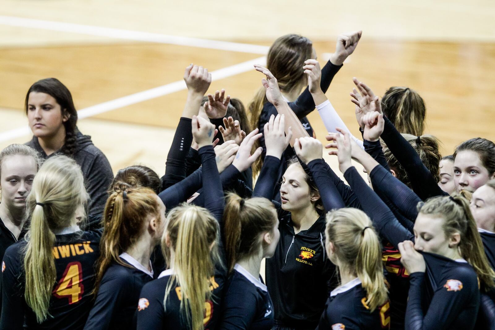 Fenwick’s players huddle during Friday’s Division II state volleyball semifinal against Parma Heights Holy Name at Wright State University’s Nutter Center. NICK GRAHAM/STAFF