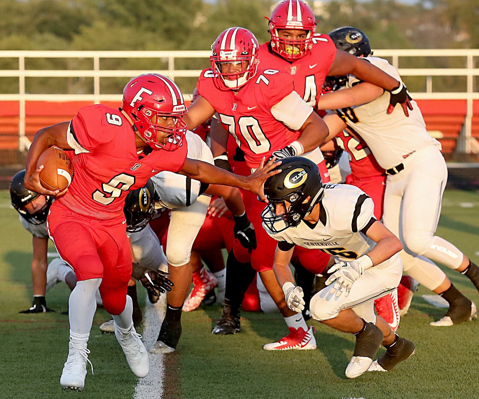 Fairfield running back Jutahn McClain stiff-arms Centerville defensive back Evan Franzman on a two-point conversion run Friday night at Fairfield Stadium. The visiting Elks won 30-23 in the Skyline Chili Crosstown Showdown affair. CONTRIBUTED PHOTO BY E.L. HUBBARD