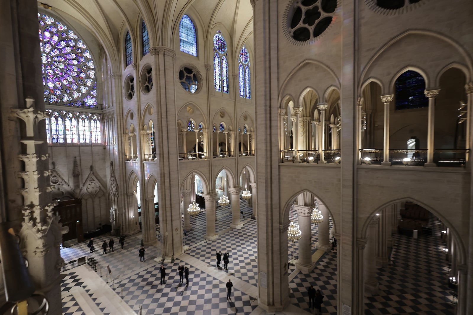 People stroll in Notre-Dame de Paris cathedral while French President Emmanuel Macron visits the restored interiors the monument, Friday, Nov.29, 2024 in Paris. (Christophe Petit Tesson, Pool via AP)