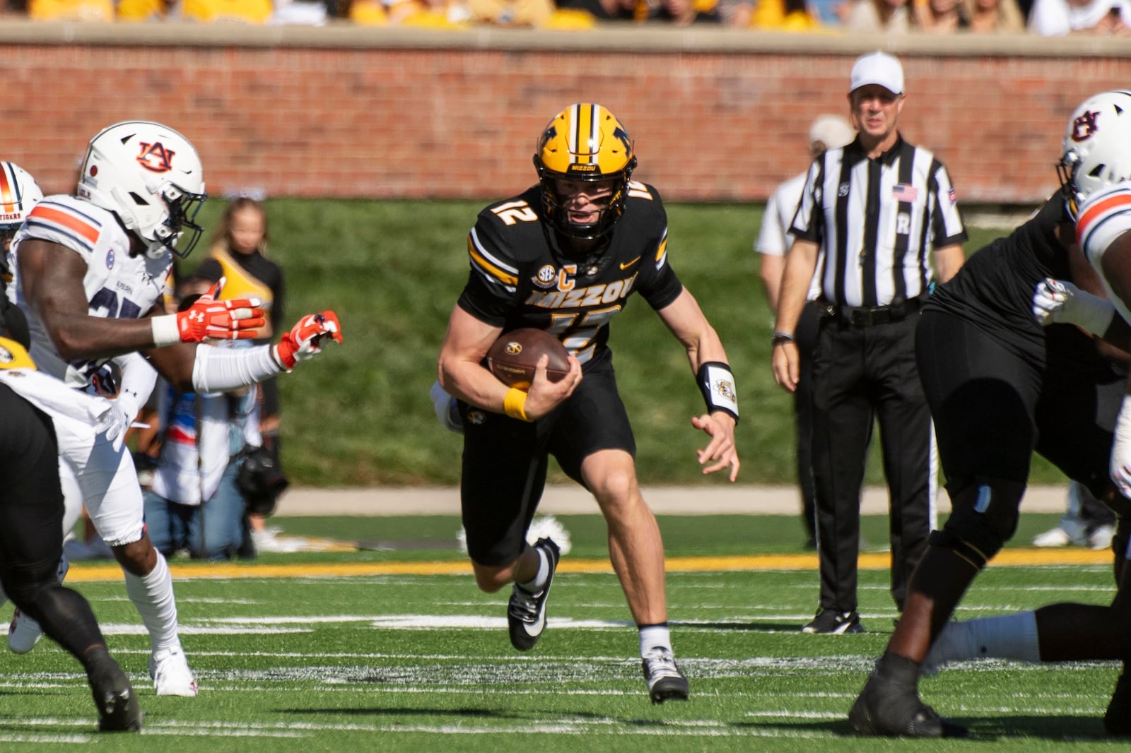 Missouri quarterback Brady Cook (12) scrambles out of the pocket during the first half of an NCAA college football game against Auburn Saturday, Oct. 19, 2024, in Columbia, Mo. (AP Photo/L.G. Patterson)