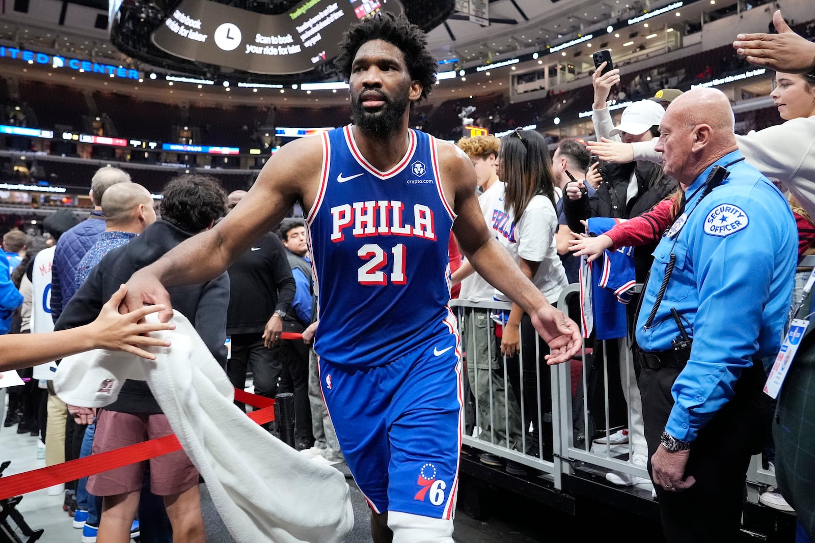 Philadelphia 76ers center Joel Embiid (21) celebrates with fans as he walks off the court after his team defeated the Chicago Bulls in an NBA basketball game in Chicago, Sunday, Dec. 8, 2024. (AP Photo/Nam Y. Huh)