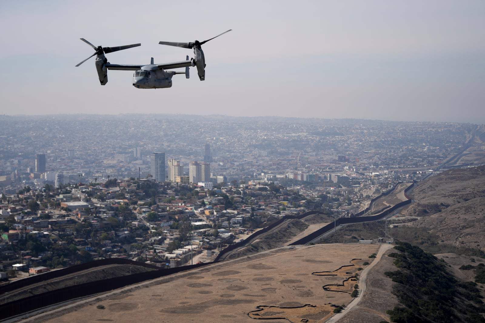 A U.S. Marine Osprey is flown over the border Friday, Jan. 31, 2025, near San Diego. (AP Photo/Jae C. Hong)