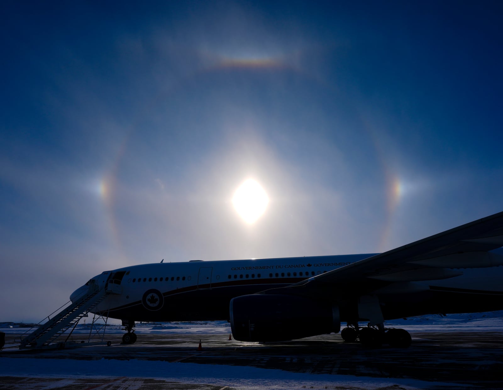 A sundog is pictured over the Canadian Prime Minister's plane in Iqaluit, Nunavut, Tuesday, March 18, 2025. (Sean Kilpatrick/The Canadian Press via AP)