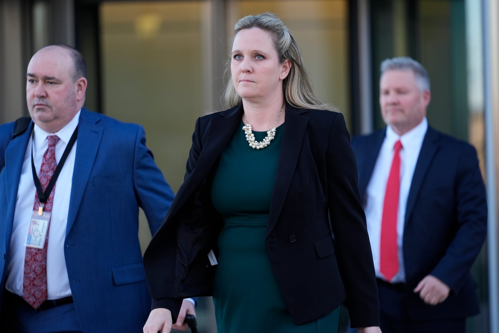 From left, Will County State's attorneys Christopher Koch, Christine Vukmir and Michael Fitzgerald leave the Will County Courhouse after the first day of the trial of Joseph Czuba, 73, who is charged with the fatal stabbing of six-year-old Palestinian boy Wadee Alfayoumiand and the wounding of his mother Hanan Shaheen, Tuesday, Feb. 25, 2025, in Joliet, Ill. (AP Photo/Erin Hooley)