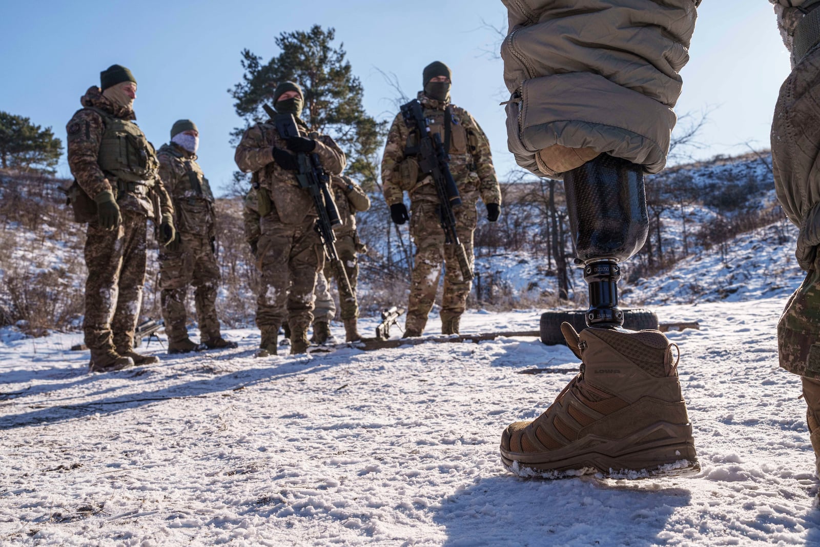 Serhii Pozniak, a sniper unit commander with the 27th national guard brigade, speaks to soldiers during military training near Kyiv, Ukraine, on Feb. 17, 2025. (AP Photo/Evgeniy Maloletka)