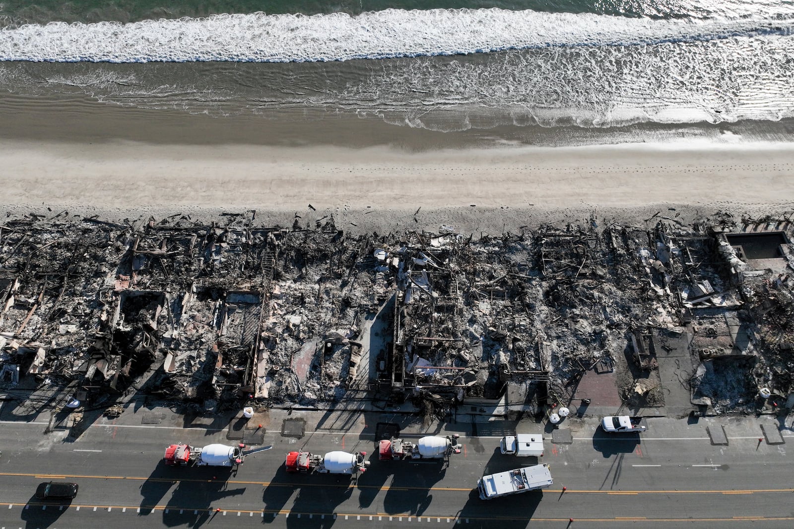 An aerial view shows the devastation from the Palisades Fire on beachfront homes Wednesday, Jan. 15, 2025 in Malibu, Calif. (AP Photo/Jae C. Hong)