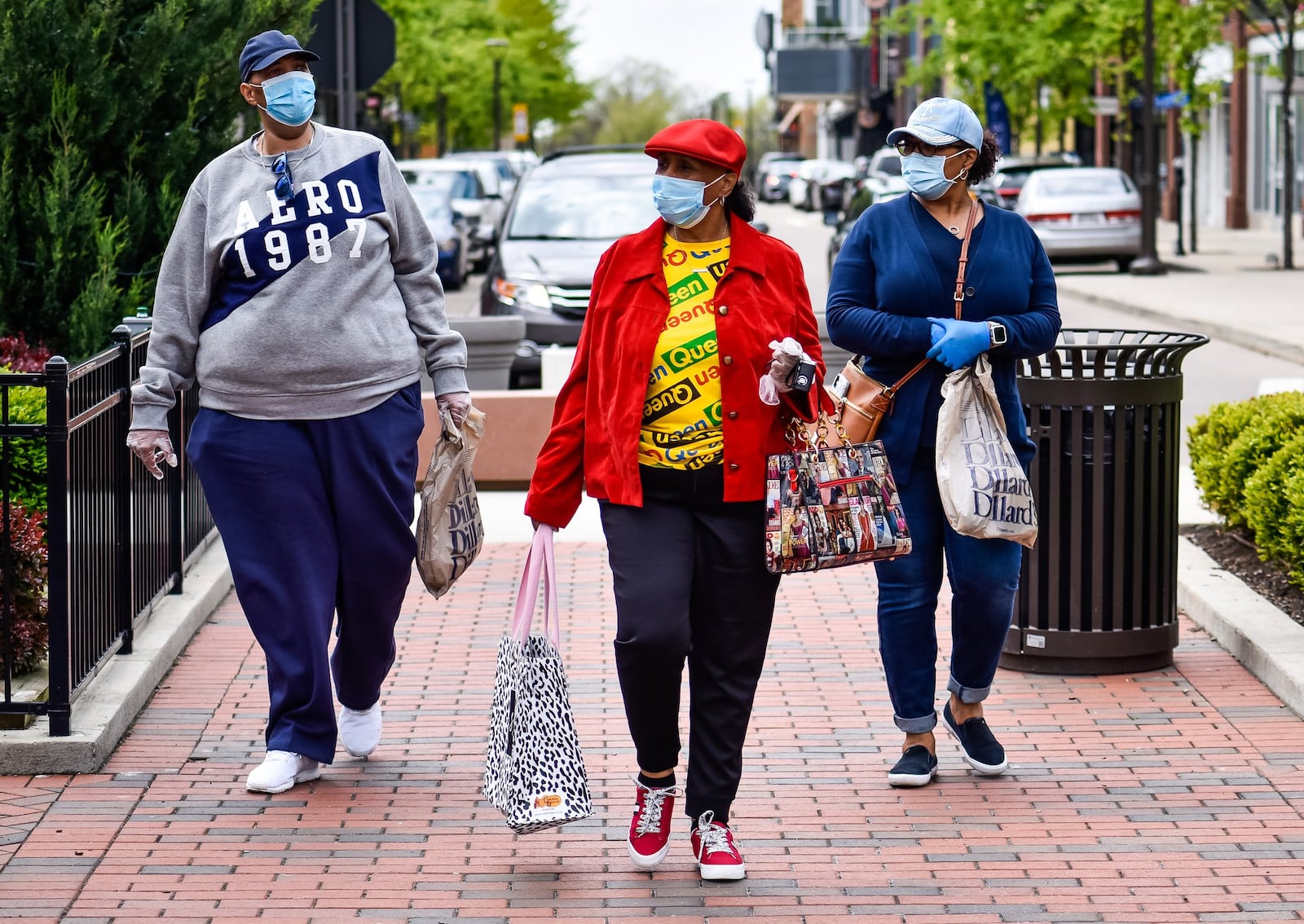 Joey Shields, left, Josephine Gates, middle, and Shelley Gates wear masks as they shop at Liberty Center in Liberty Township on the first day most retail stores were allowed to open Tuesday, May 12, 2020. Most non-essential retail stores have been closed to the public since the stay-at-home order went into place due to the coronavirus pandemic. NICK GRAHAM / STAFF