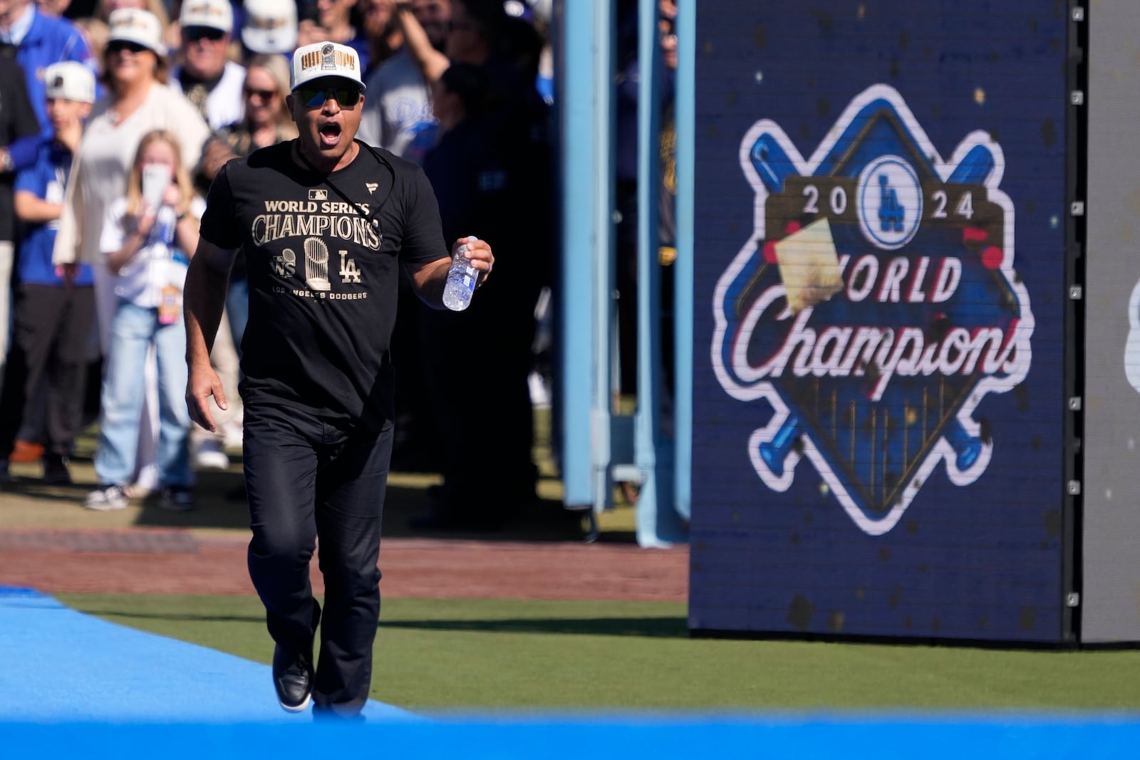 Los Angeles Dodgers manager Dave Roberts celebrates as he walks to the stage during the baseball team's World Series championship parade and celebration at Dodger Stadium, Friday, Nov. 1, 2024, in Los Angeles. (AP Photo/Mark J. Terrill)