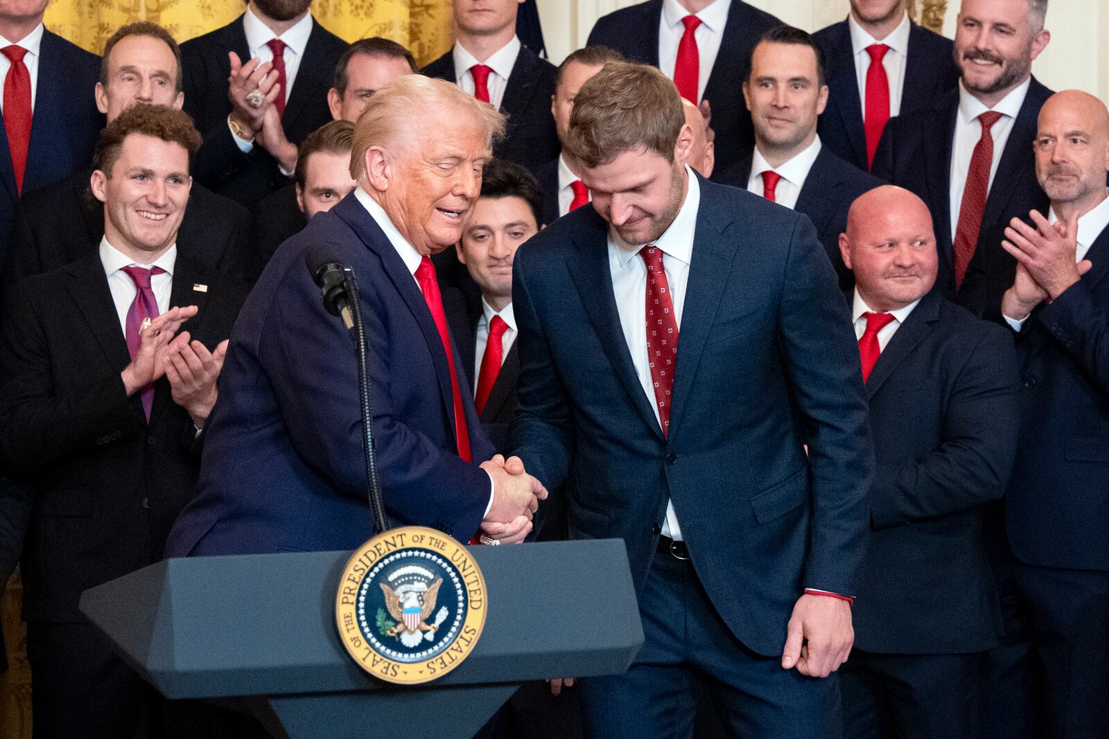 President Donald Trump shakes hands with team captain Aleksander Barkov during a ceremony with the Florida Panthers NHL hockey team to celebrate their 2024 Stanley Cup win, in the East Room of the White House, Monday, Feb. 3, 2025, in Washington. (AP Photo/Alex Brandon)