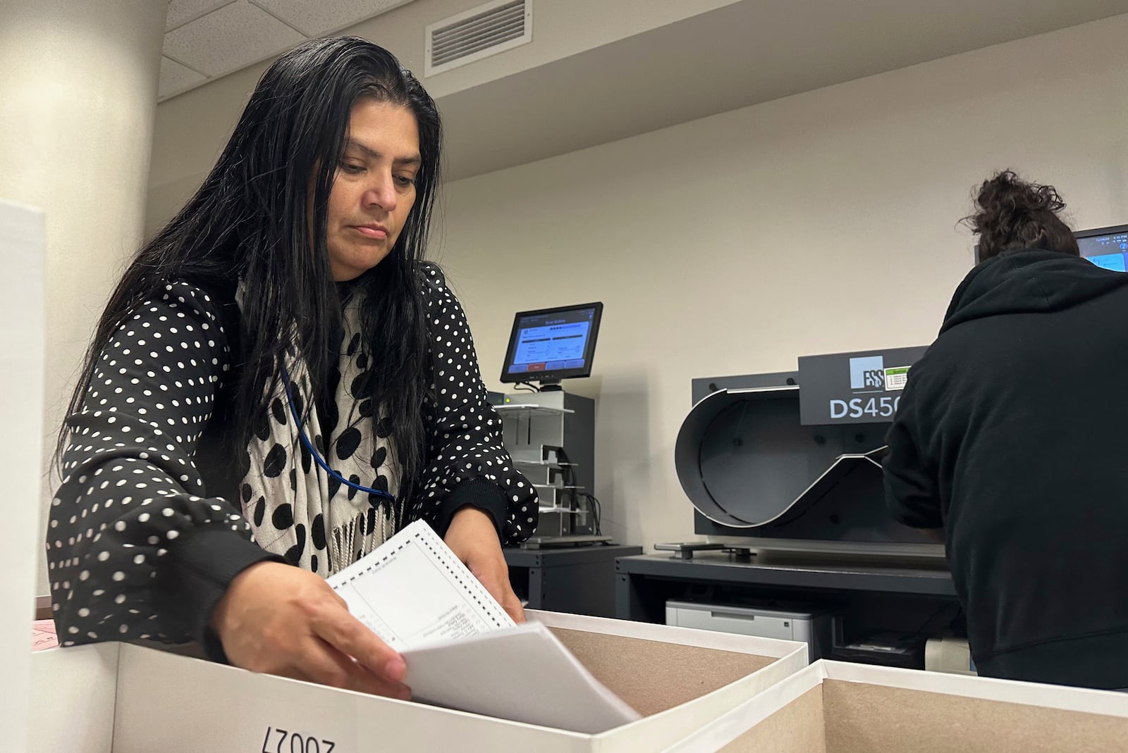 Jessica Cabrera works with a stack of ballots during a state-mandated recount of the U.S. Senate race at the Lehigh County Government Center in Allentown, Pa., Tuesday, Nov. 19, 2024. (AP Photo/Michael Rubinkam)