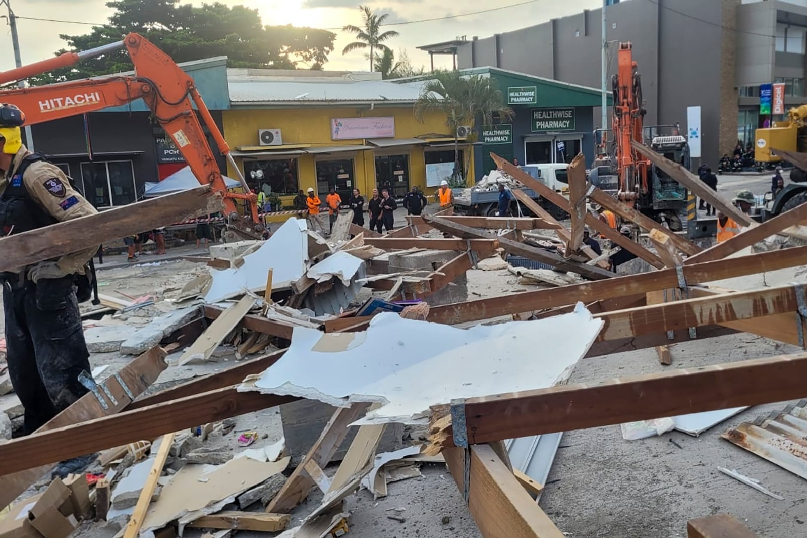 In this photo released by Department of Foreign Affairs and Trade (DFAT), Australian rescue workers inspect a damaged building in Port Vila, Vanuatu Thursday, Dec. 19, 2024, following a powerful earthquake that struck just off the coast of Vanuatu in the South Pacific Ocean. (DFAT via AP)