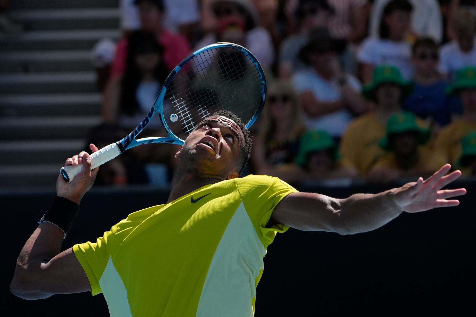 Giovanni Mpetshi Perricard of France serves to compatriot Gael Monfils during their first round match at the Australian Open tennis championship in Melbourne, Australia, Tuesday, Jan. 14, 2025. (AP Photo/Asanka Brendon Ratnayake)