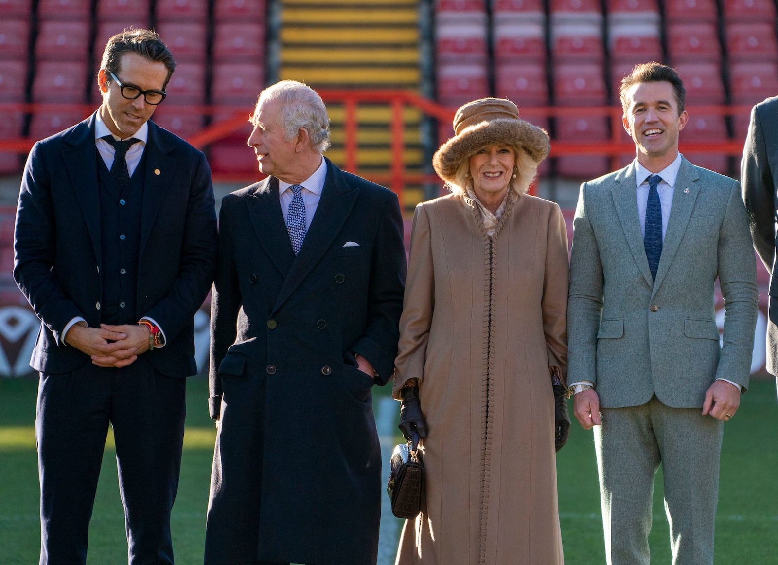 FILE - Britain's King Charles III, second left and Camilla, the Queen Consort speak to Wrexham soccer club co-owners, US actors Ryan Reynolds, left and Rob McElhenney during their visit to Wrexham Football Club's Racecourse Ground, in Wrexham, Wales, Friday, Dec. 9, 2022. (Arthur Edwards/Pool Photo via AP)