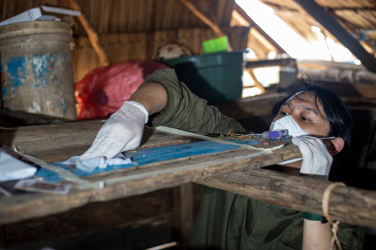 Dhany Alfalah, a researcher for Satya Bumi, a nonprofit environmental organization, collects dust samples from a house on Kabaena Island in South Sulawesi, Indonesia, Friday, Nov. 15, 2024. (AP Photo/Yusuf Wahil)