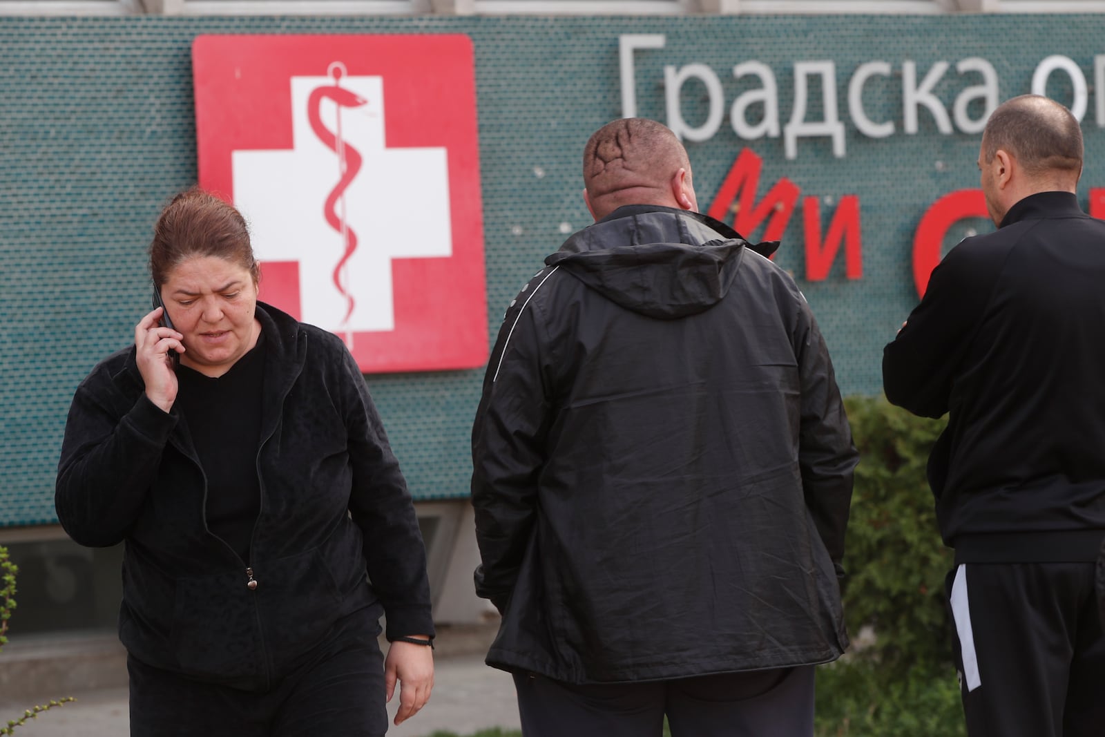 A person makes a telephone call in front of the hospital in Skopje, North Macedonia, Sunday, March 16, 2025, after a massive fire in a nightclub in the town of Kocani. (AP Photo/Boris Grdanoski)