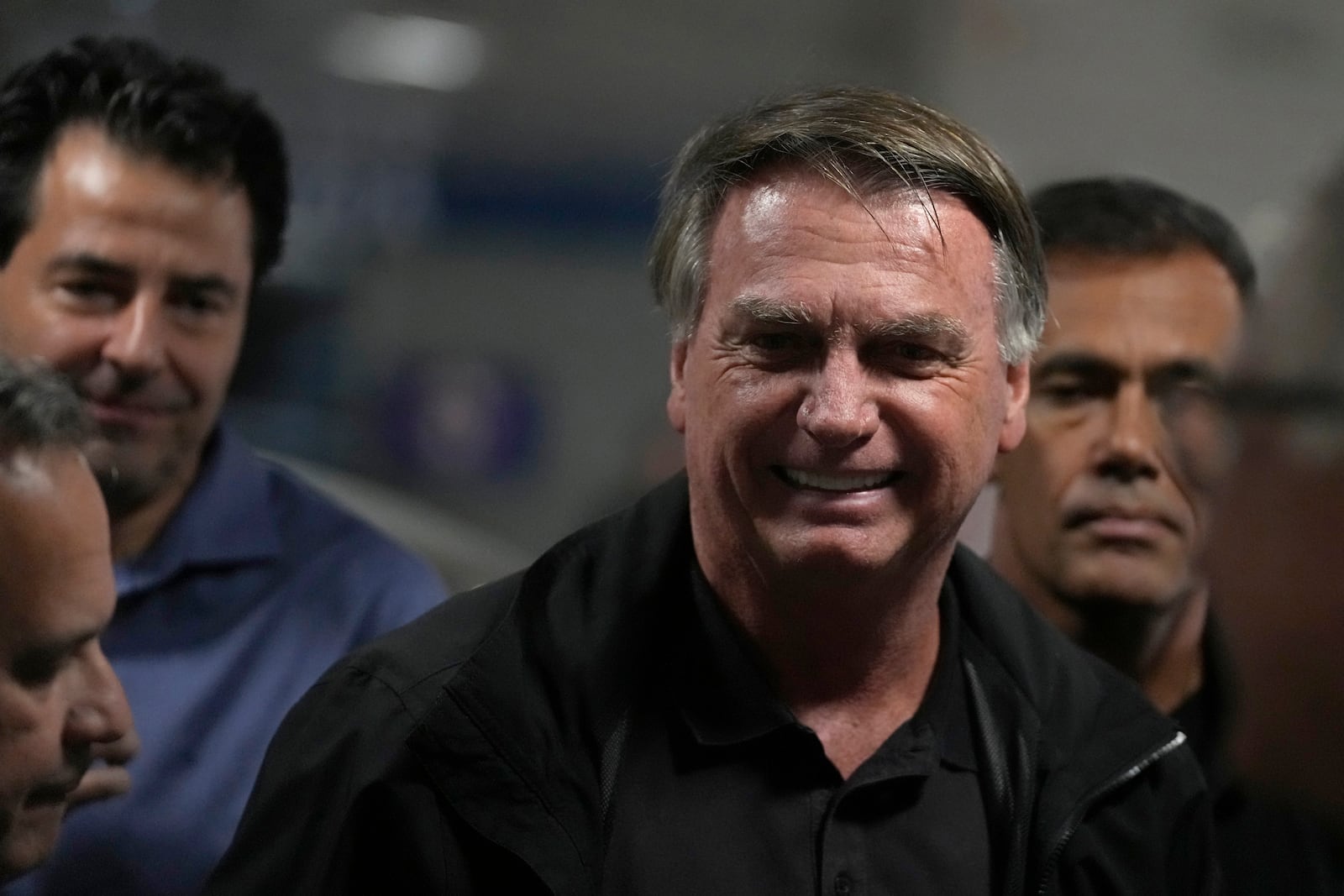 Former Brazilian President Jair Bolsonaro arrives for a luncheon with senators from his support base, at the National Congress building in Brasilia, Brazil, Tuesday, Feb. 18, 2025. (AP Photo/Eraldo Peres)