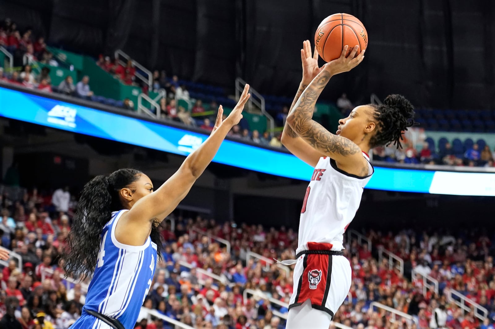 NC State guard Aziaha James (10) shoots over Duke guard Reigan Richardson (24) during an NCAA college basketball game in the championship of the Atlantic Coast Conference tournament Greensboro, N.C., Sunday, March 9, 2025. (AP Photo/Chuck Burton)