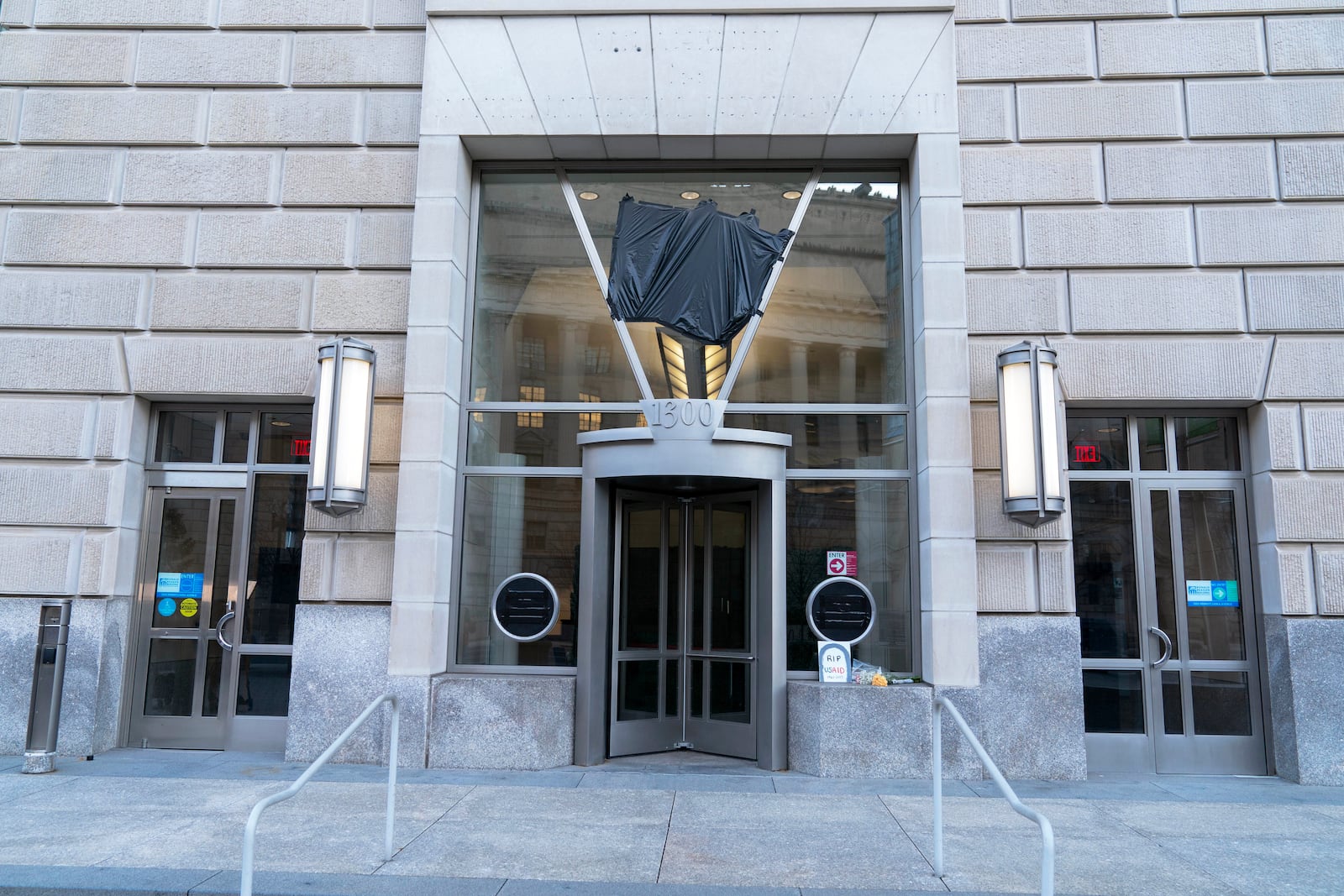 The door of the U.S. Agency for International Development, or USAID, is seen with the sign and logo removed from the wall outside of the agency's headquarters in Washington, Friday, Feb. 7, 2025. (AP Photo/Jose Luis Magana)