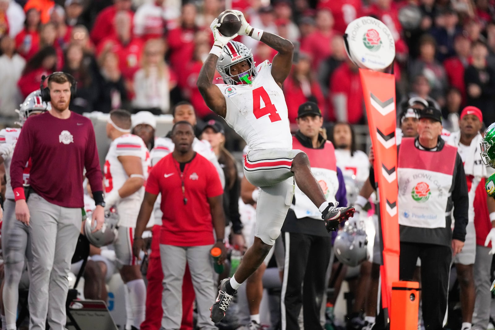 Ohio State wide receiver Jeremiah Smith (4) catches a pass during the second half in the quarterfinals of the Rose Bowl College Football Playoff against Oregon, Wednesday, Jan. 1, 2025, in Pasadena, Calif. (AP Photo/Mark J. Terrill)