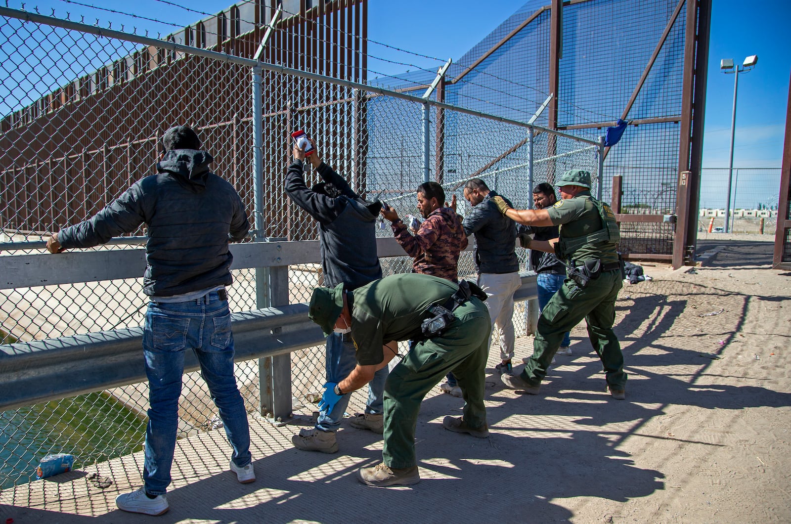 FILE - Migrants are pat down by Border Patrol agents as they enter into El Paso, Texas from Ciudad Juarez, Mexico, May 10, 2023. (AP Photo/Andres Leighton, File)