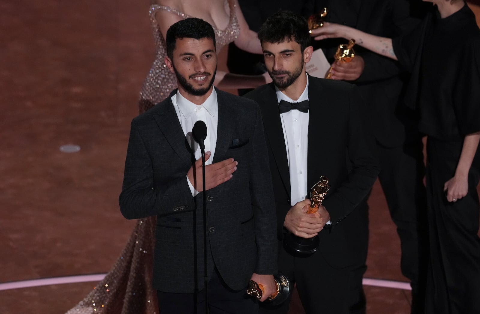 Basel Adra, left, and Yuval Abraham accept the award for best documentary feature film for "No Other Land" during the Oscars on Sunday, March 2, 2025, at the Dolby Theatre in Los Angeles. (AP Photo/Chris Pizzello)