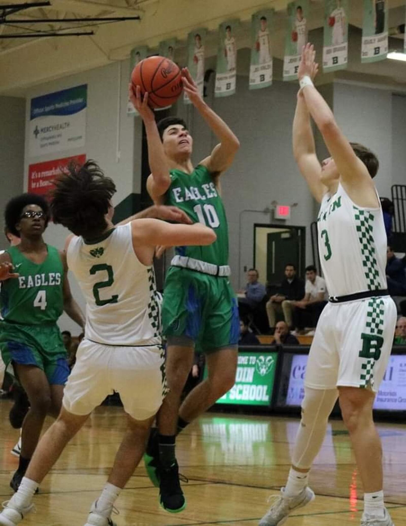 Chaminade Julienne’s Jack Nauseef (10) drives between Seth Hargis (2) and Nathan Hegemann (3) of Badin during Friday night’s game at Mulcahey Gym in Hamilton. CJ won 58-54. CONTRIBUTED PHOTO BY TERRI ADAMS