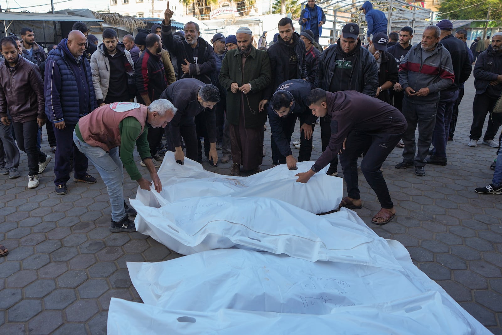 Bodies of victims of an Israeli airstrike at the Nuseirat refugee camp are prepared for the funeral prayer outside the Al-Aqsa Martyrs hospital in Deir al-Balah, Gaza Strip, Saturday, Dec. 21, 2024. (AP Photo/Abdel Kareem Hana)