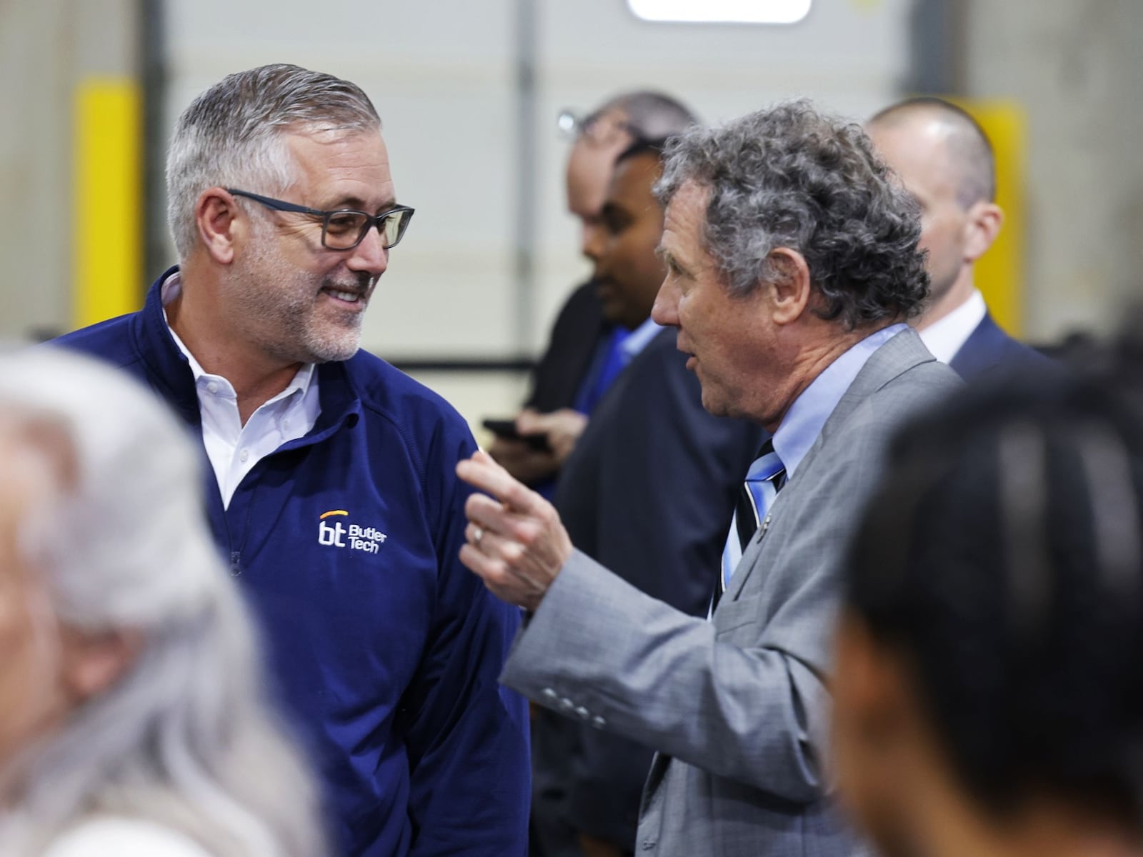 Butler Tech Superintendent and CEO Jon Graft, left, talks to Senator Sherrod Brown before President Joe Biden speaks at United Performance Metals Friday, May 6, 2022 in Hamilton. NICK GRAHAM/STAFF