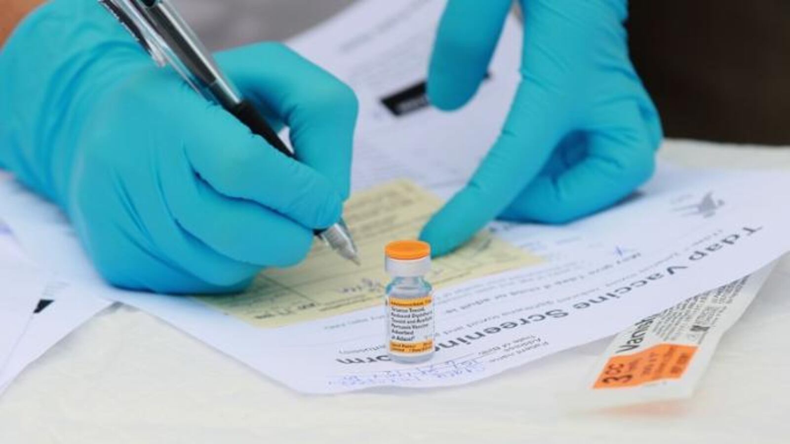 In this file photo, Touro University medical student Shamis Fallah prepares paperwork before adminstering a Tdap vaccination during the Solano County health fair Aug. 11, 2010, in Vallejo, California.