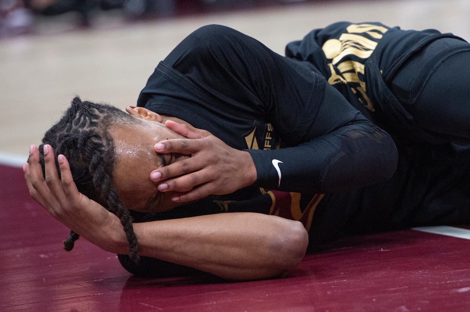 Cleveland Cavaliers' Darius Garland reacts after an injury during the first half of an NBA basketball game against the New York Knicks in Cleveland, Friday, Feb. 21, 2025. (AP Photo/Phil Long)