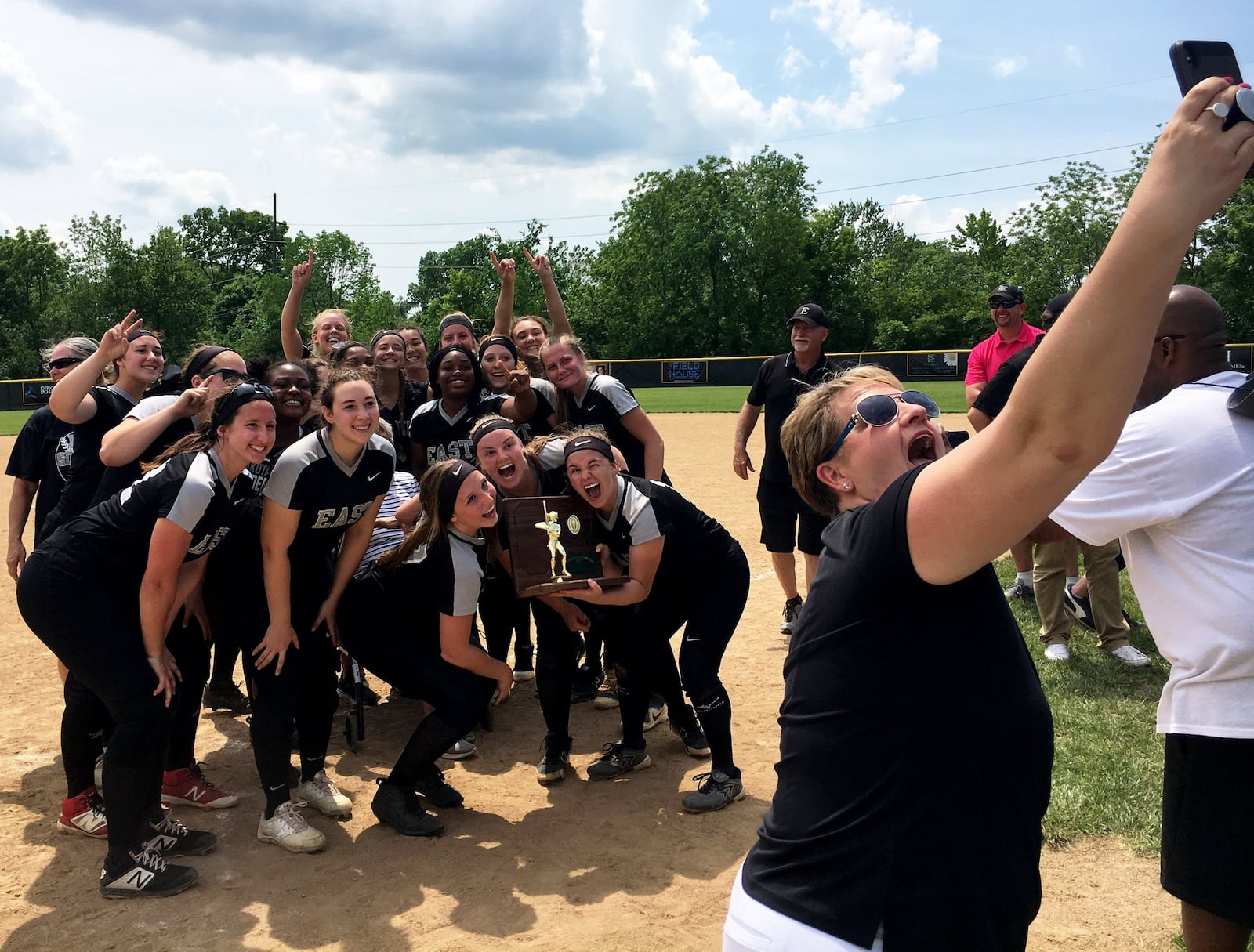 It’s selfie time for Lakota East’s softball team Saturday after the Thunderhawks captured a Division I regional championship with a 2-1 win over Lakota West at Centerville. RICK CASSANO/STAFF