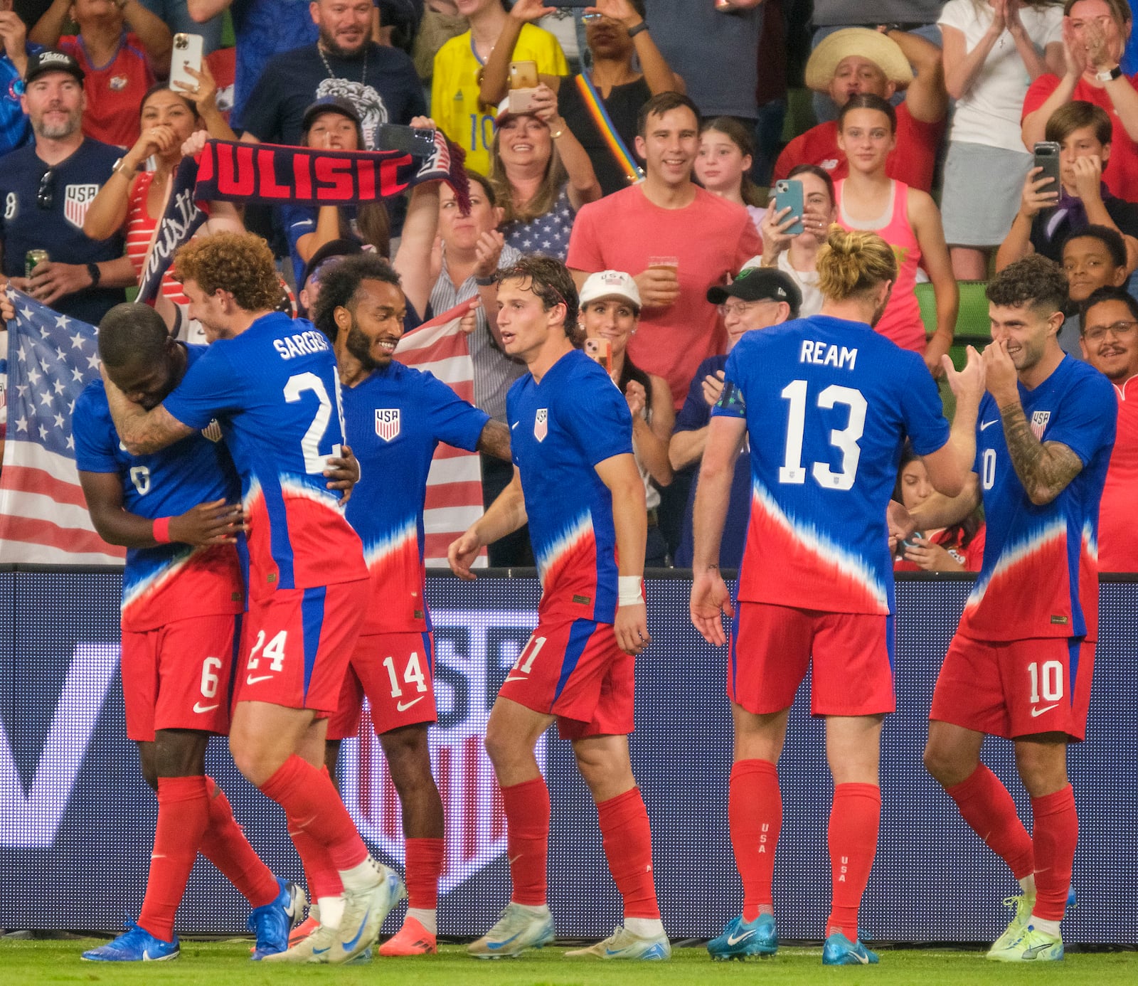 United States midfielder Yunus Musah (6), left, celebrates with forward Josh Sargent (24) and teammates after scoring against Panama during the second half of an international friendly soccer match, Saturday, Oct. 12, 2024, in Austin, Texas. (AP Photo/Rodolfo Gonzalez)