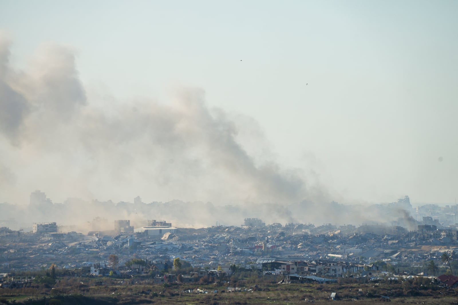 Smoke rises following an explosion in the Gaza Strip as seen from southern Israel, Wednesday, Dec.18, 2024. (AP Photo/Ohad Zwigenberg)