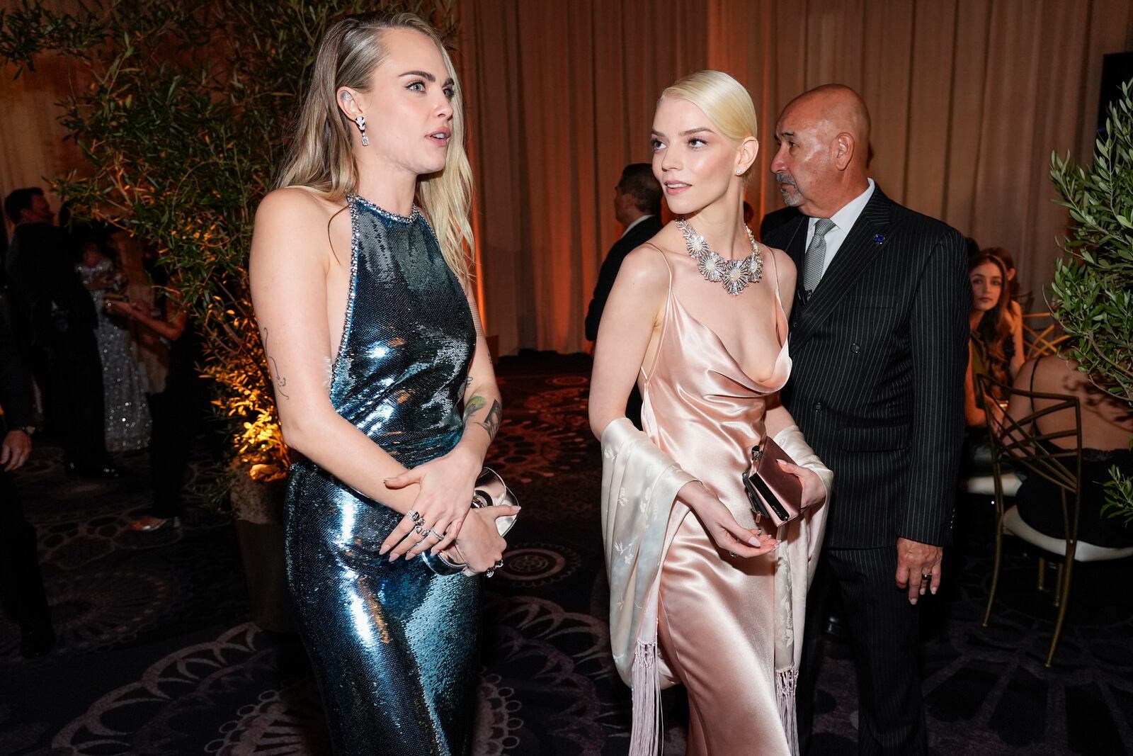 Cara Delevingne, left, and Anya Taylor-Joy arrive at the 82nd Golden Globes on Sunday, Jan. 5, 2025, at the Beverly Hilton in Beverly Hills, Calif. (AP Photo/Chris Pizzello)