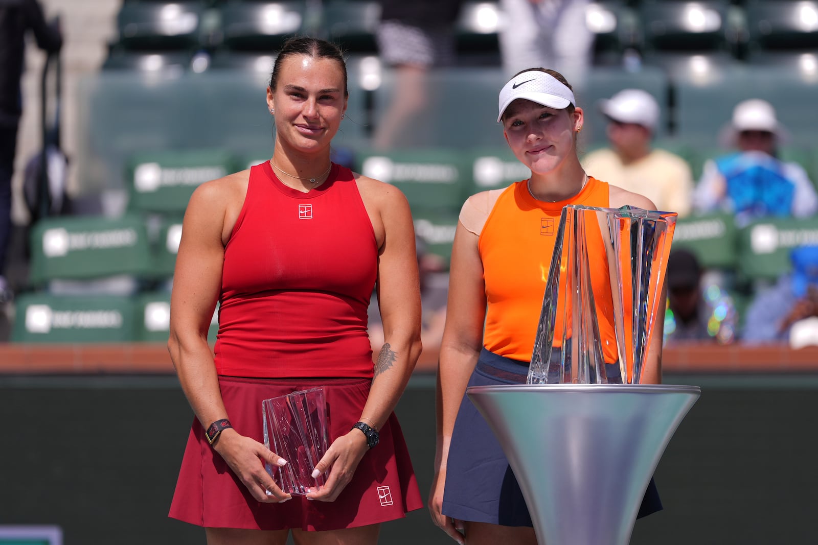 Aryna Sabalenka, of Belarus, and Mirra Andreeva, of Russia, pose for photos after the final match at the BNP Paribas Open tennis tournament Sunday, March 16, 2025, in Indian Wells, Calif. (AP Photo/Mark J. Terrill)