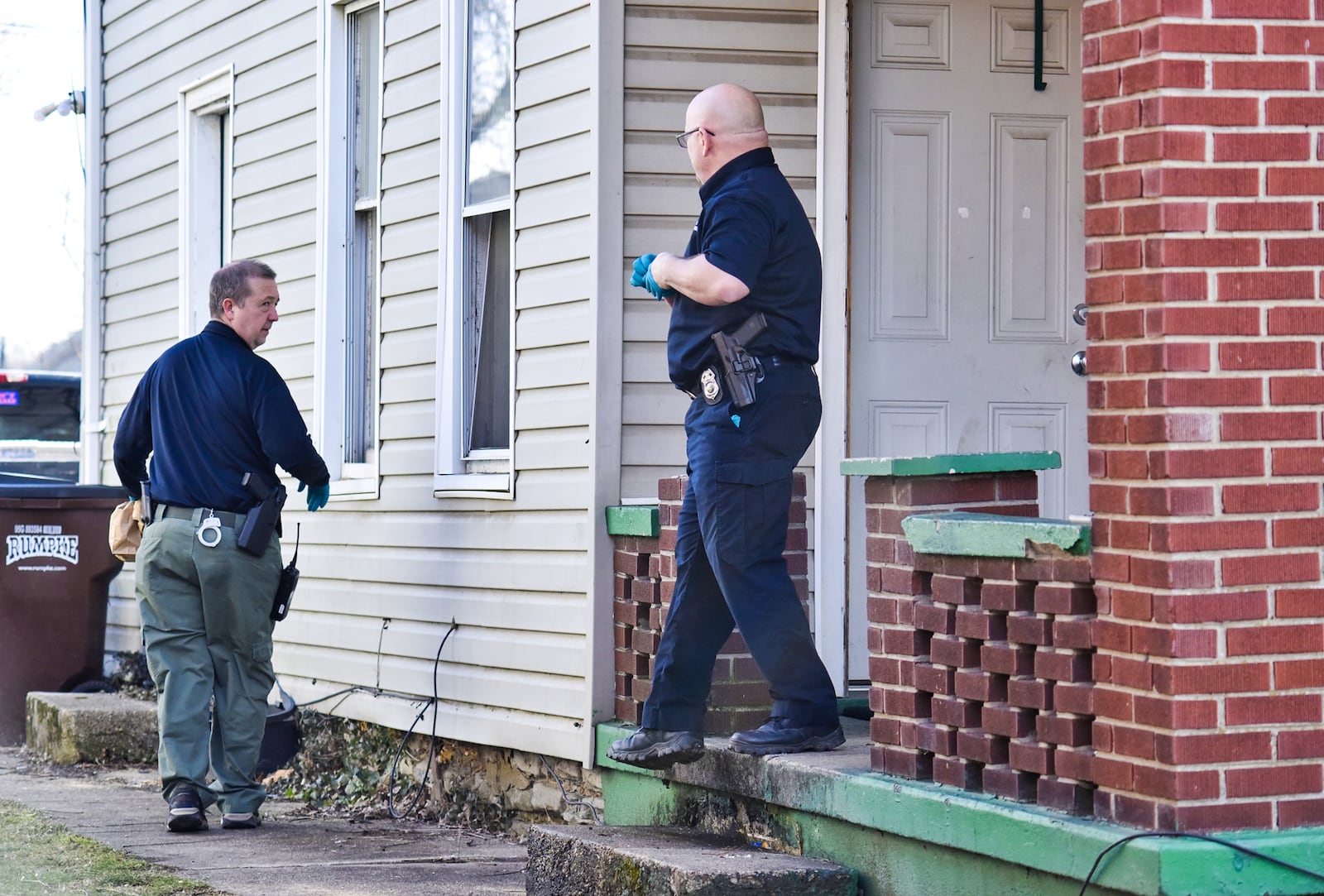 Middletown Detective Tom McIntosh, left, and Detective Jon Hoover at the Crawford Street home of Brittany Gosney and James Hamilton. The couple were charged on Sunday, Feb. 28, 2021 in connection to the death of 6-year-old James Robert Hutchinson of Middletown. James Hamilton admitted to police he kept the boy’s body in this Crawford Street house and then took part in disposing of it in the Ohio River. NICK GRAHAM / STAFF