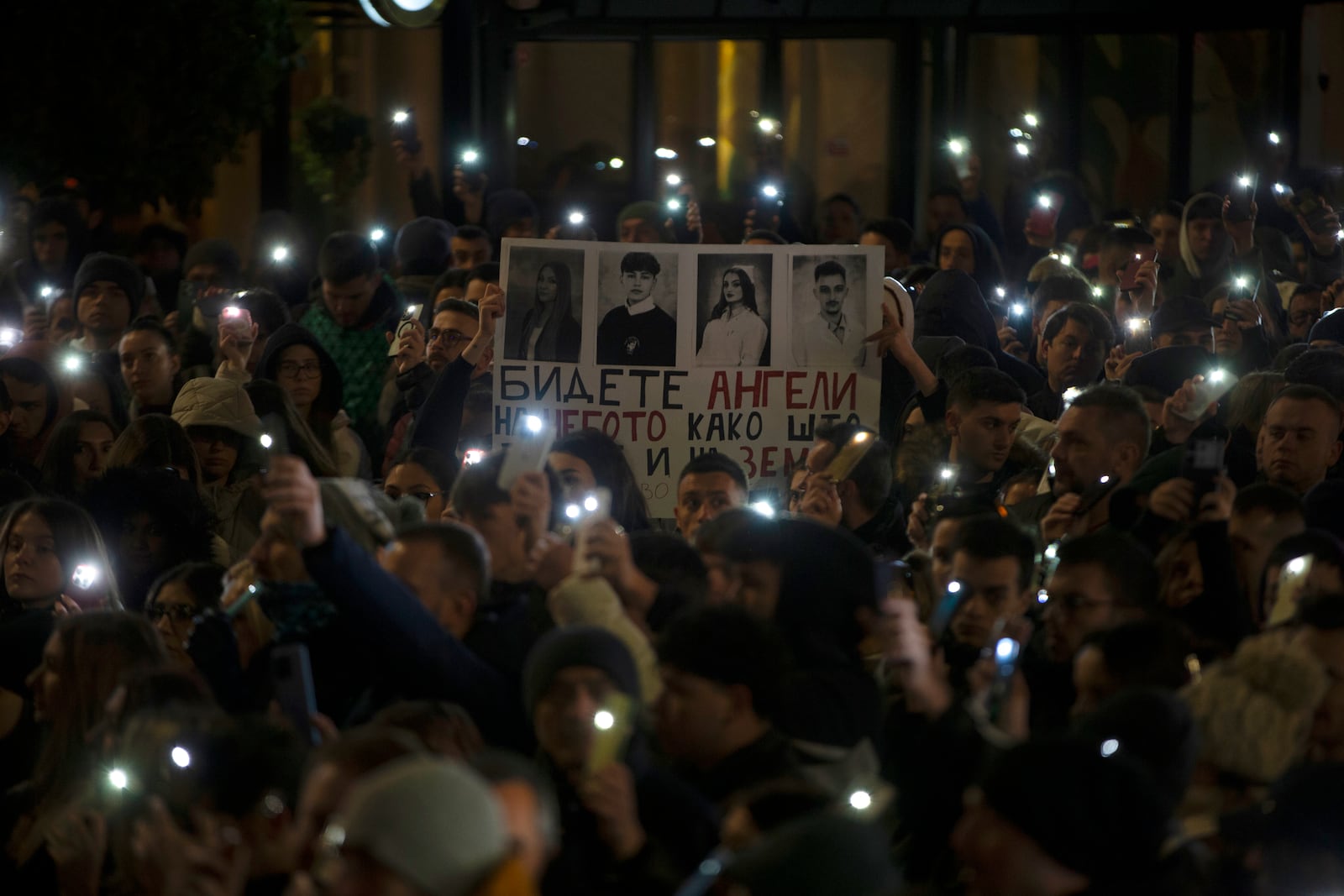 Protesters hold placards as thousands gather in protest for the victims of a massive nightclub fire in the town of Kocani, in Skopje, North Macedonia, Tuesday, March 18, 2025. (AP Photo/Visar Kryeziu)