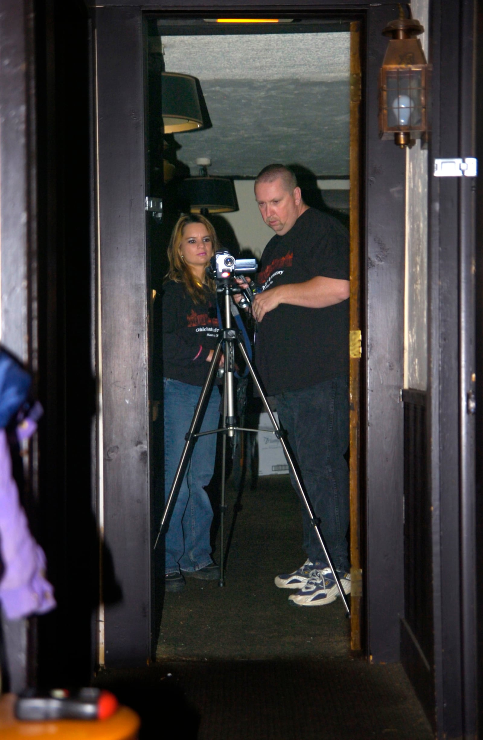 FROM THE ARCHIVES: Debbie Eldridge and Dave Adams set up a video camera in the upstairs hallway at the Trail Tavern in Yellow Springs in 2006. BILL LACKEY/STAFF