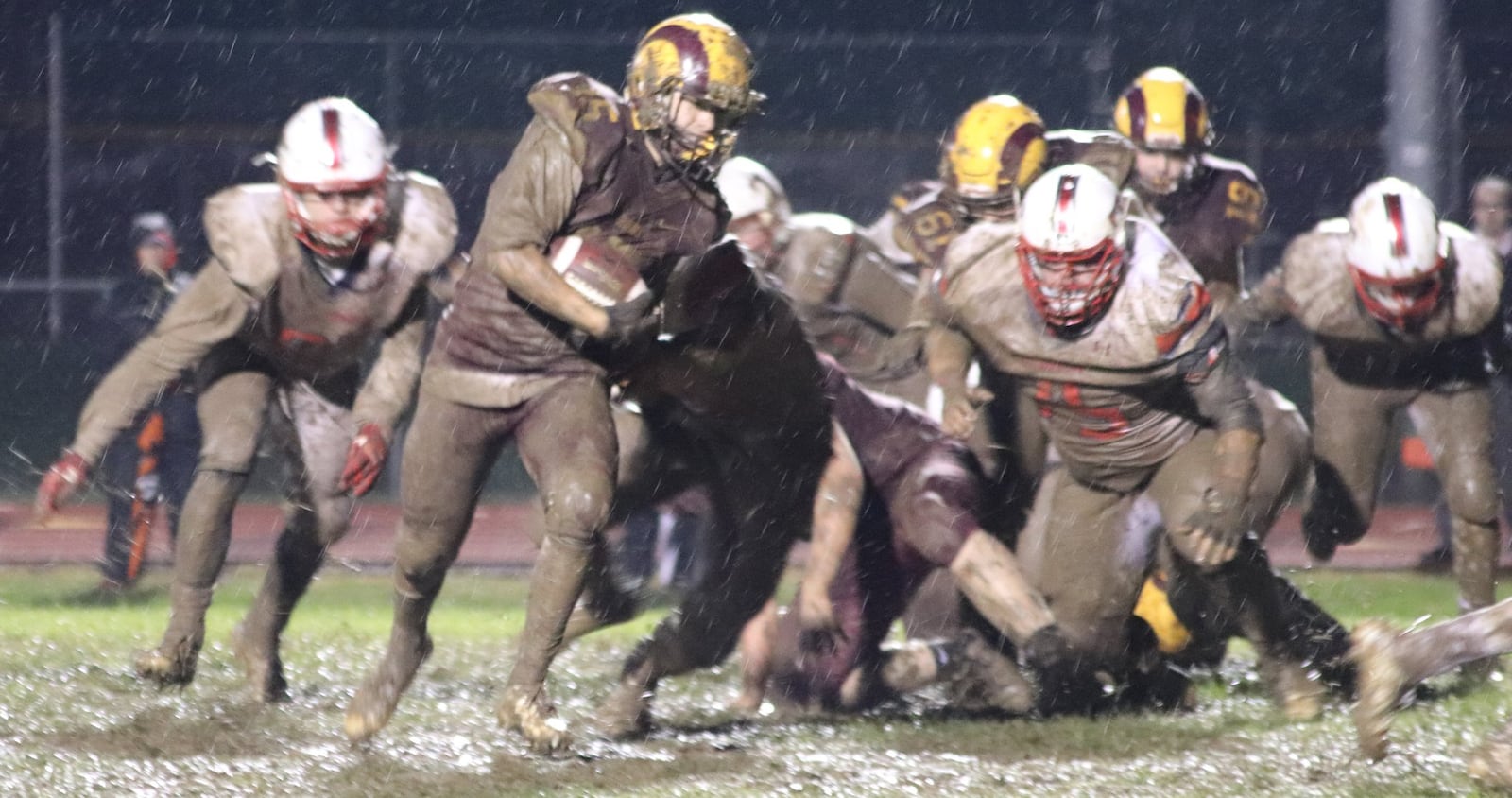 Dylan Caldwell of Ross runs through the mud during an 18-7 victory over visiting Talawanda at Robinson Field in Ross Township on Oct. 26. CONTRIBUTED PHOTO BY KAREN REDEMEIER