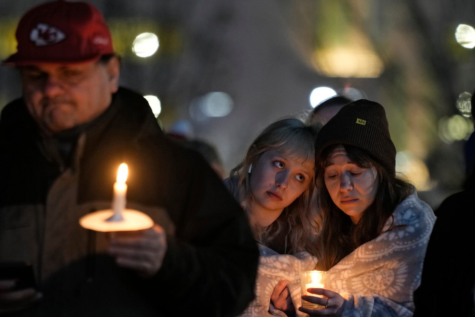 FILE - People attend a candlelight vigil for victims of a shooting at a Kansas City Chiefs Super Bowl victory rally Thursday, Feb. 15, 2024 in Kansas City, Mo. (AP Photo/Charlie Riedel, File)