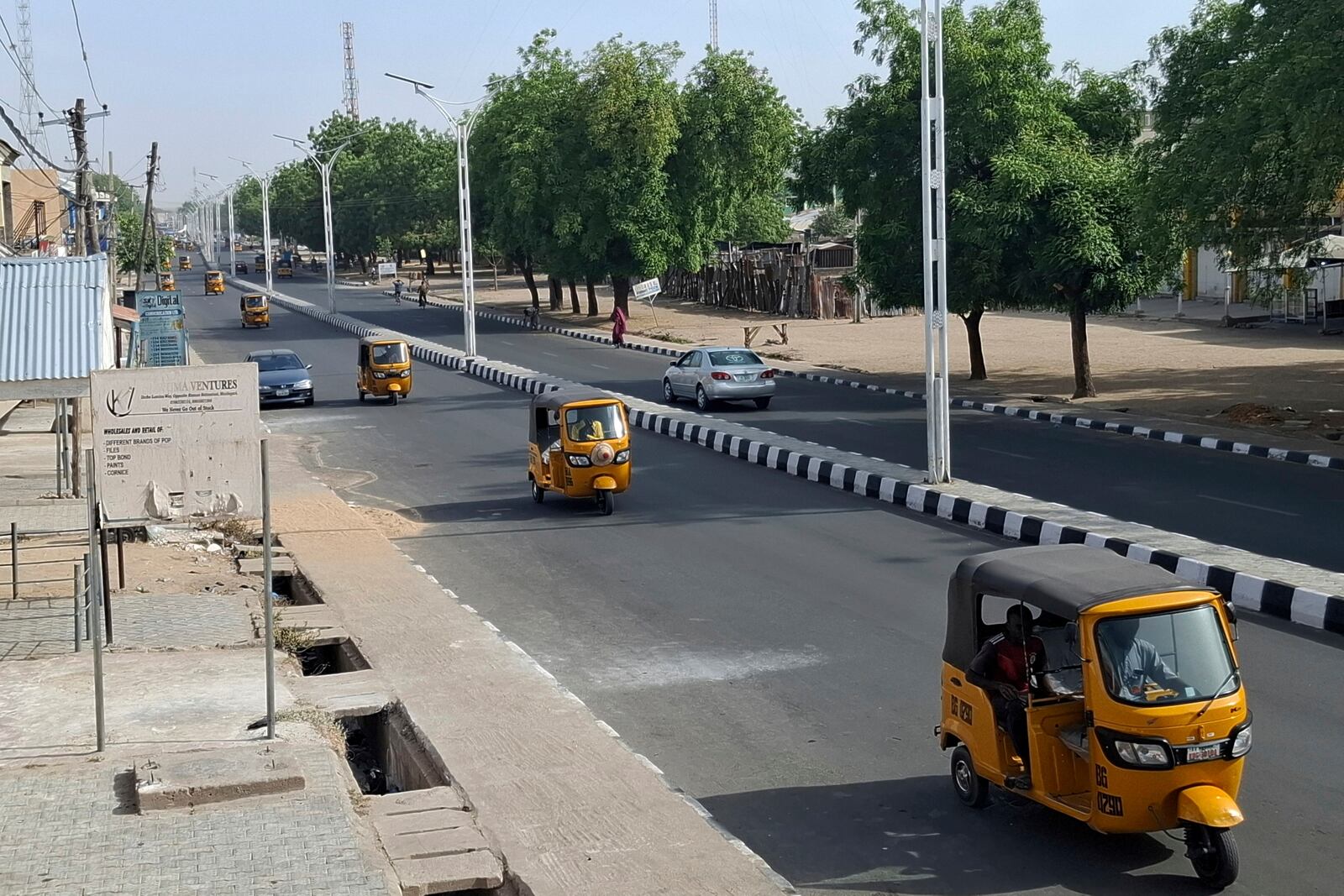 Taxis drive on a street in Maiduguri, Nigeria, Friday, March 14, 2025. (AP Photo/Joshua Olatunji)