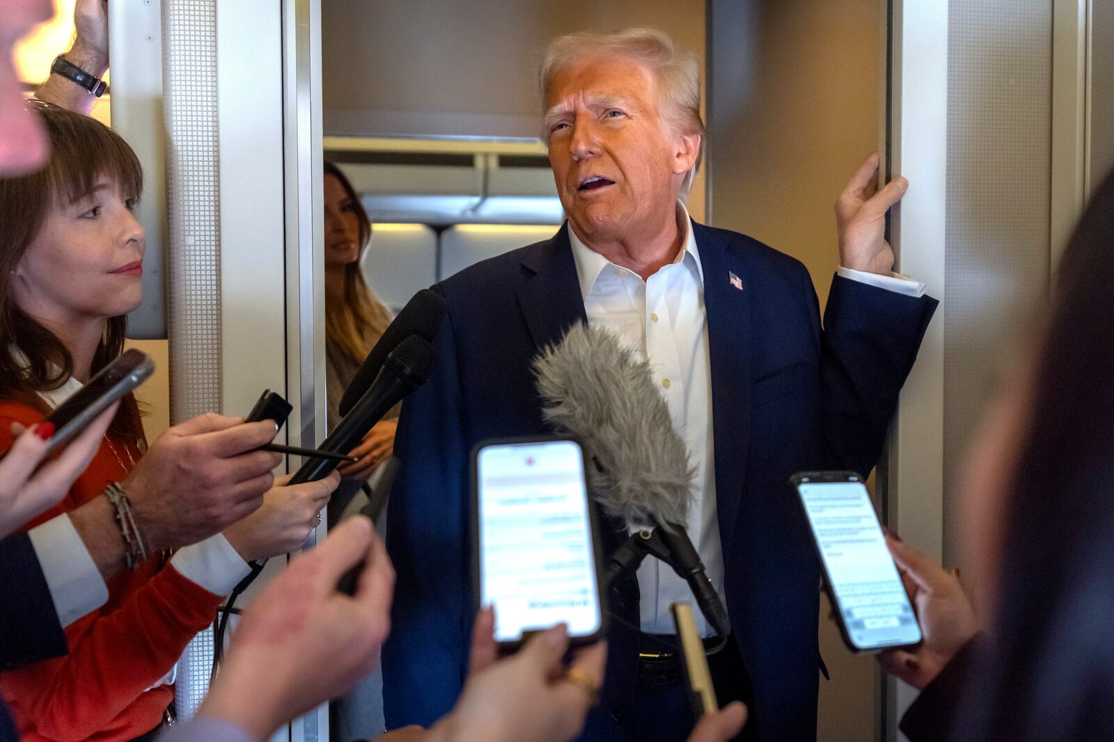 President Donald Trump speaks to reporters aboard Air Force One as he travels from Las Vegas to Miami on Saturday, Jan. 25, 2025. (AP Photo/Mark Schiefelbein)