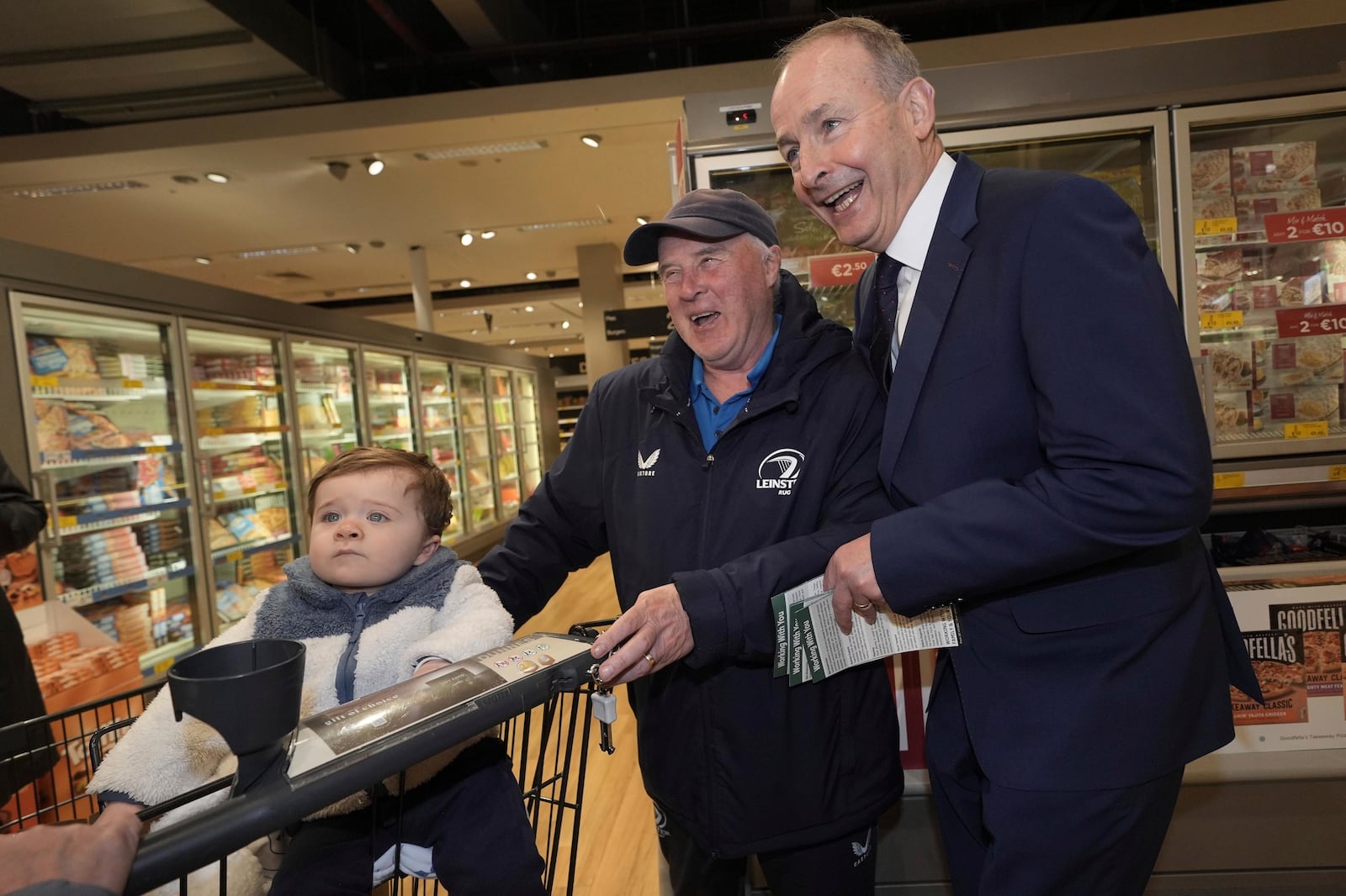 Tanaiste and Fianna Fail leader Micheal Martin, right, meets Barney Hynes and his grandson Wyatt McLoughlin in Arklow, Ireland, on the last day of campaigning on the eve of the General Election, Thursday Nov. 28, 2024. (Brian Lawless/PA via AP)