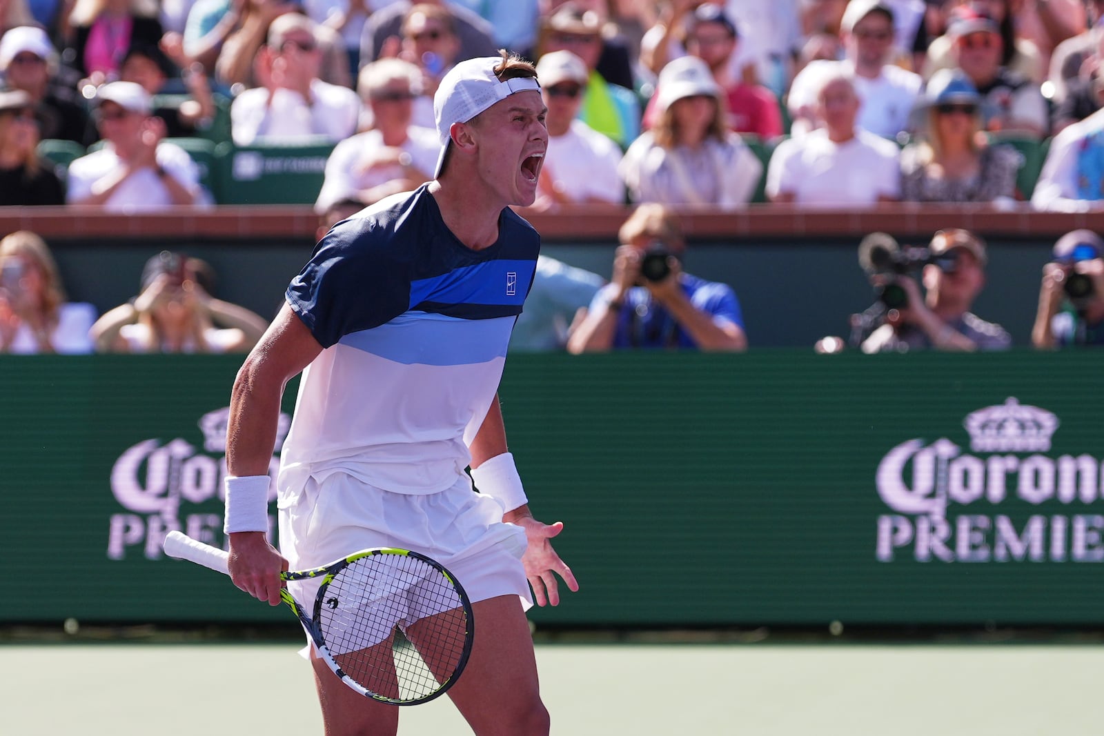 Holger Rune, of Denmark, celebrates after defeating Daniil Medvedev, of Russia, in their semifinals match at the BNP Paribas Open tennis tournament Saturday, March 15, 2025, in Indian Wells, Calif. (AP Photo/Mark J. Terrill)