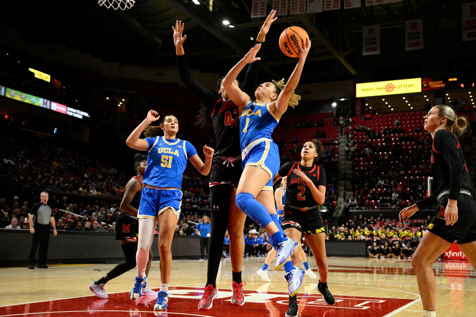 UCLA guard Kiki Rice (1) goes to the basket against Maryland forward Amari DeBerry (42) during the first half of an NCAA college basketball game, Sunday, Jan. 26, 2025, in College Park, Md. (AP Photo/Nick Wass)